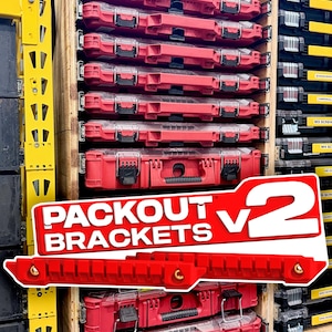 May include: A wooden storage rack holding multiple red and clear plastic tool organisers. In the foreground, two red plastic mounting brackets are displayed with the text PACKOUT BRACKETS v2 printed in white on a red background overlay.