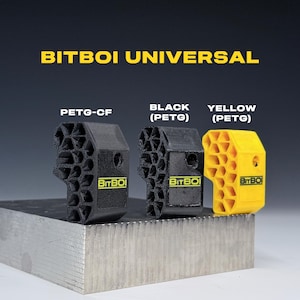 May include: Three Bitboi Universal components featuring a honeycomb-patterned side and a solid side with the text Bitboi. The items are labelled PETG-CF, Black PETG, and Yellow PETG. Each piece has a circular hole on the side and a flat base.