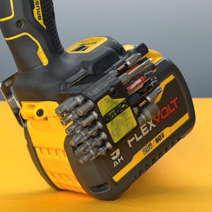 May include: A black 3D-printed bit holder attached to a yellow and black DeWalt FlexVolt 20V/60V battery pack. The holder contains multiple metal screwdriver bits and is mounted on the side of the battery, which is connected to a power tool handle.