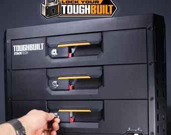 May include: A black ToughBuilt StackTech three-drawer storage unit with a lockable mechanism on each drawer. The unit features the ToughBuilt logo and a Lock Your ToughBuilt graphic at the top. A key is inserted into the bottom drawer lock.