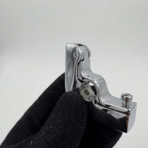 May include: A set of three ceramic mugs with a speckled, matte finish. The mugs are in shades of cream, light gray, and dark gray. Each mug has a simple, modern design and a rounded handle.