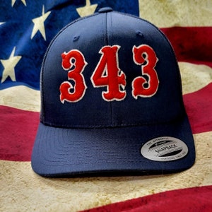 May include: A navy blue trucker hat with a red mesh back. The front of the hat features the number "343" in large, white-outlined, red letters.