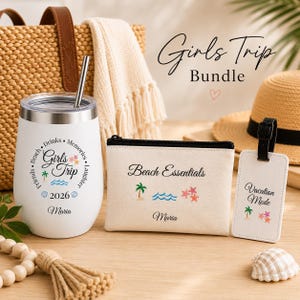 May include: A white stainless steel tumbler with a metal straw, a beige canvas zipper pouch, and a white luggage tag. The tumbler features the text Girls Trip 2026 Maria, the pouch says Beach Essentials Maria, and the tag says Vacation Mode.
