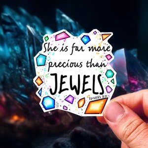 May include: A white sticker with colorful geometric shapes and the text "She is far more precious than JEWELS. PROVERBS 31:10".