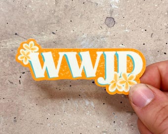 May include: Orange sticker with the text "WWJD" in white letters with a blue outline. The sticker has two yellow flowers with white centers on either side of the text.