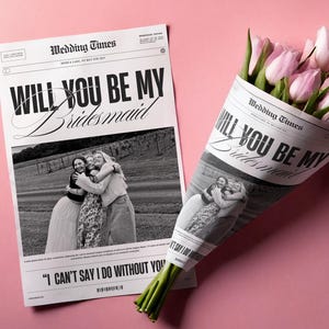 May include: A black and white newspaper with the text "Will You Be My Bridesmaid" and a photo of three women hugging. The newspaper is wrapped around a bouquet of pink tulips.
