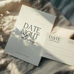 May include: Two white cards with the text "DATE NIGHT ideas" and "DATE ideas" on them. The card on the left has the text "WRITE IDEAS ON THE CARDS BELOW". The card on the right has the text "FOR THE FUTURE MR & MRS. NAME" and "WITH LOVE".