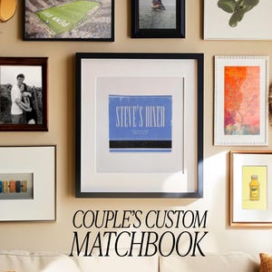May include: A framed photo collage of various images, including a couple, a diner, a tree, and a bottle. The collage is displayed on a wall with a beige background. The text "COUPLE'S CUSTOM MATCHBOOK" is written below the collage.