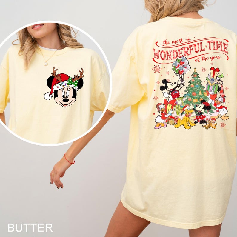 Puede incluir: Una camiseta amarilla con un personaje de Mickey Mouse que lleva un gorro de Pap&aacute; Noel y cuernos de reno en la parte delantera. La parte posterior de la camiseta presenta una escena navide&ntilde;a con Mickey Mouse y sus amigos, incluidos Donald Duck, Goofy, Pluto y Minnie Mouse. El texto "the most WONDERFUL TIME of the year" est&aacute; impreso en la parte posterior de la camiseta.