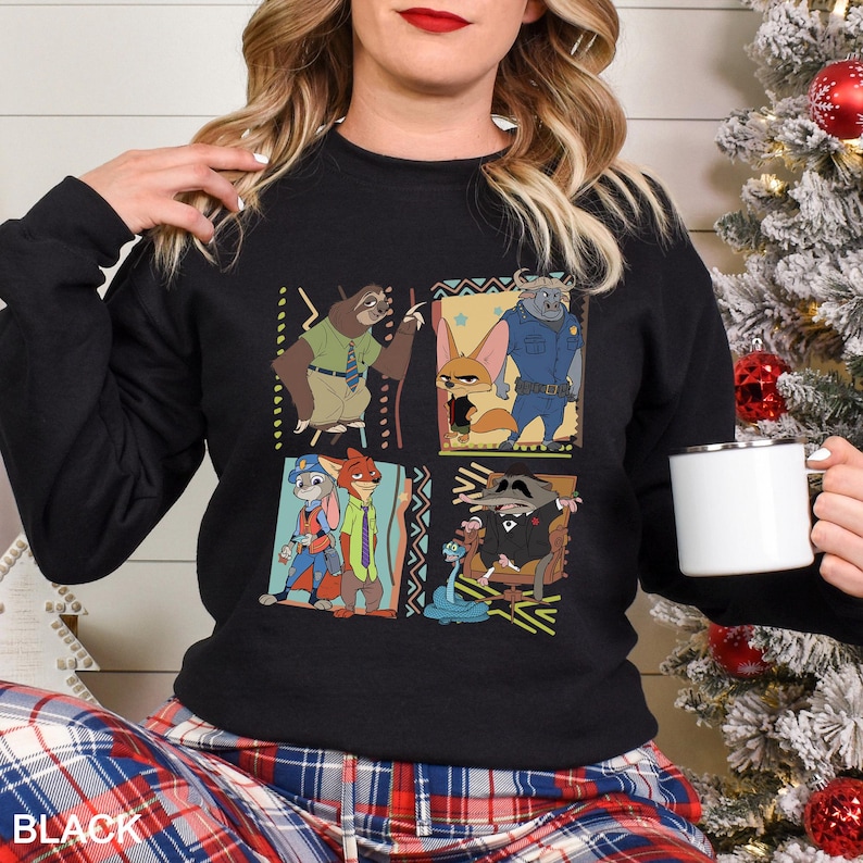 May include: Black crewneck sweatshirt featuring a colorful graphic of characters from a popular animated movie. The design includes four panels with different characters, set against decorative borders. The word "BLACK" is printed at the bottom.