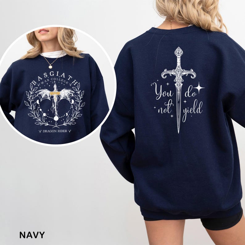 May include: Navy blue sweatshirt with white graphic designs. The front features text and a dragon-like creature with a floral wreath. The back displays a sword design with the text "You do not yield".