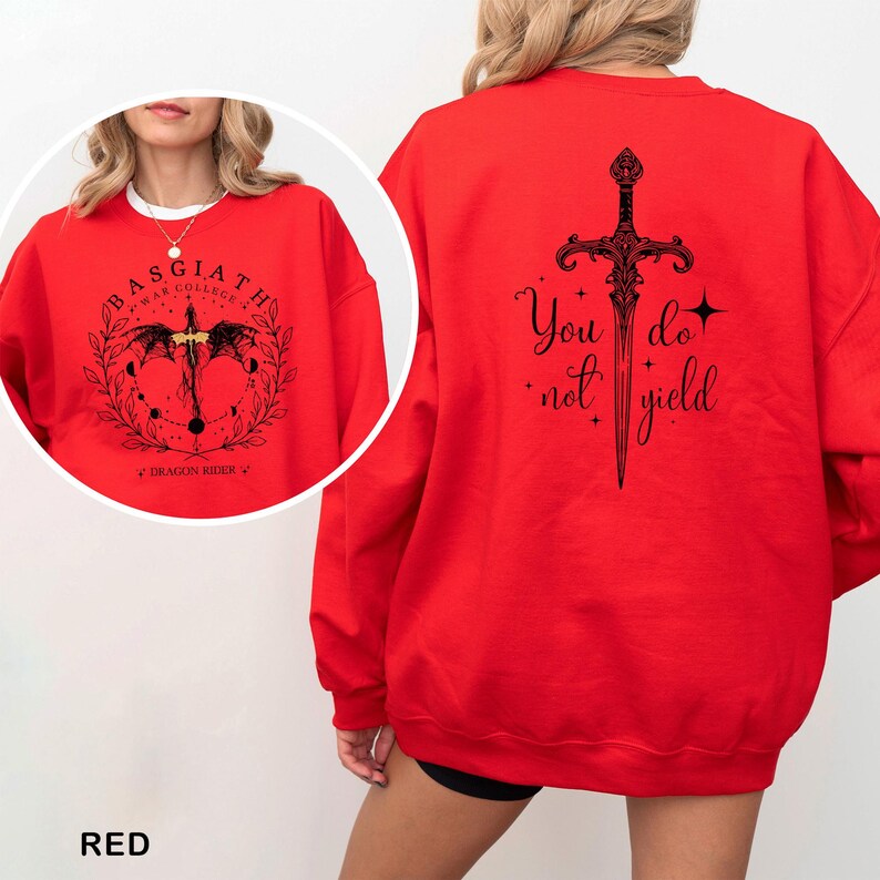 May include: A red sweatshirt with black graphic designs. The front features a circular design with text that reads "Basgiath War College" and "Dragon Rider". The back displays a sword design with the words "You do not yield".