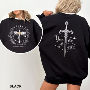 May include: Black sweatshirt with white text and graphics. The front features a circular design with the text "BASGIATH WAR COLLEGE" and a dragon graphic. The back displays a sword graphic with the words "You do not yield".