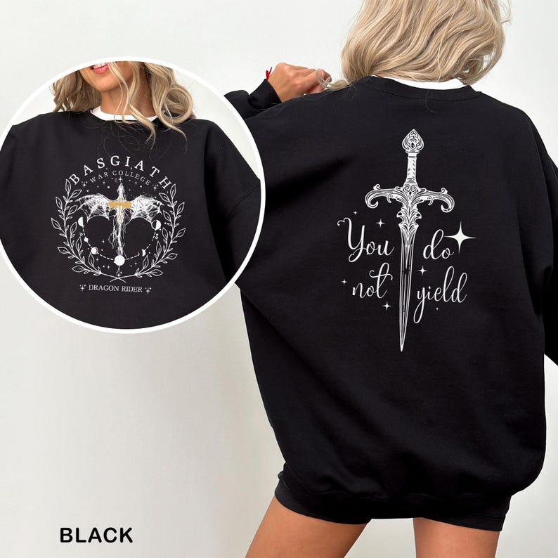 May include: Black sweatshirt with white text and graphics. The front features a circular design with the text "BASGIATH WAR COLLEGE" and a dragon graphic. The back displays a sword graphic with the words "You do not yield".
