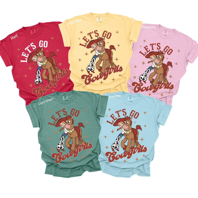 May include: Five t-shirts in different colours with the text "Let's Go Cowgirls" and a cartoon image of a horse and a girl riding the horse. The shirts are in the colours red, light green, butter, blossom, and light blue.