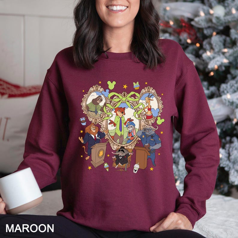 May include: Maroon sweatshirt featuring a cartoon illustration of various animal characters in a heart-shaped frame. The design includes characters in suits and uniforms, with the word "MAROON" at the bottom.