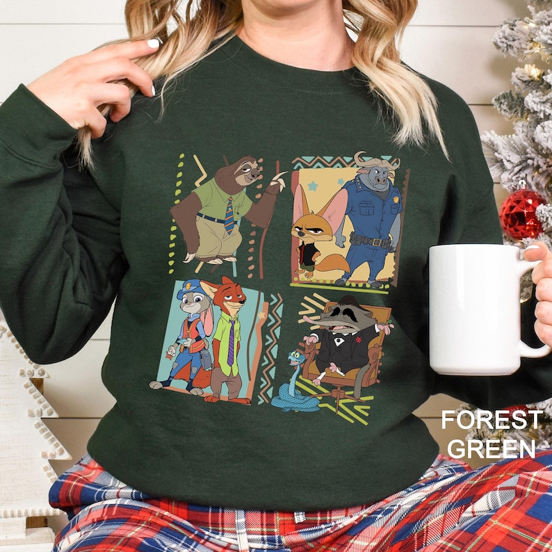May include: Forest green sweatshirt featuring a colorful cartoon design with characters from Zootopia. The design includes a sloth, fox, bunny, and other characters in a square pattern. The text "FOREST GREEN" is at the bottom.