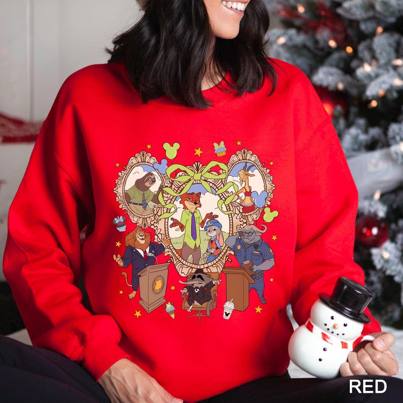 May include: A red sweatshirt featuring a cartoon illustration of characters from a popular animated movie. The design includes a central heart-shaped frame with various animal characters, surrounded by decorative elements and the word "RED" at the bottom.