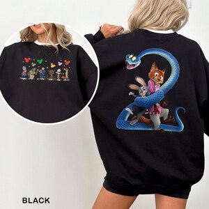 May include: Black sweatshirt featuring colorful cartoon characters on the front and a large graphic on the back. The back graphic depicts a blue snake wrapped around a fox and a rabbit. The sweatshirt has a white collar.