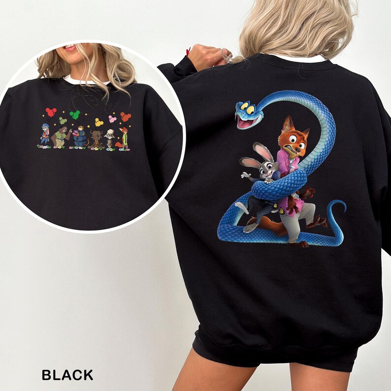 May include: Black sweatshirt featuring colorful cartoon characters on the front and a large graphic on the back. The back graphic depicts a blue snake wrapped around a fox and a rabbit. The sweatshirt has a white collar.