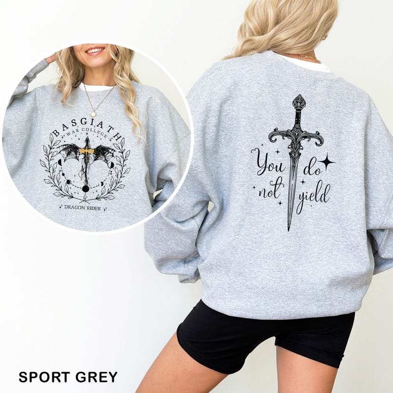May include: Sport grey sweatshirt with a graphic on the front that says "BASGIATH WAR COLLEGE" with a dragon design. The back of the sweatshirt has a sword graphic and the words "You do not yield".