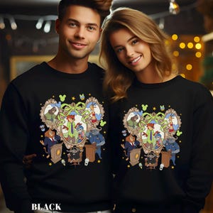 May include: Black sweatshirts featuring a cartoon design with animal characters in a framed portrait. The design includes a fox, bunny, giraffe, and other animals. The word "BLACK" is printed at the bottom of the sweatshirt.