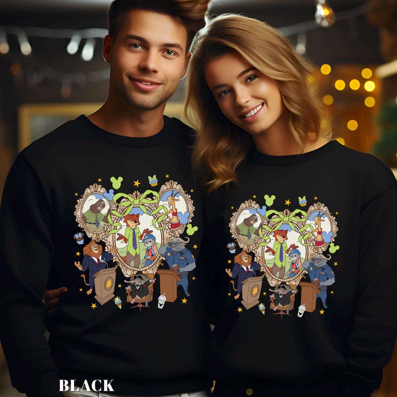 May include: Black sweatshirts featuring a cartoon design with animal characters in a framed portrait. The design includes a fox, bunny, giraffe, and other animals. The word "BLACK" is printed at the bottom of the sweatshirt.