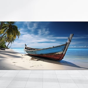 May include: A weathered wooden boat with blue and red paint sits on a white sandy beach. Palm trees line the shore and the turquoise ocean is in the background.