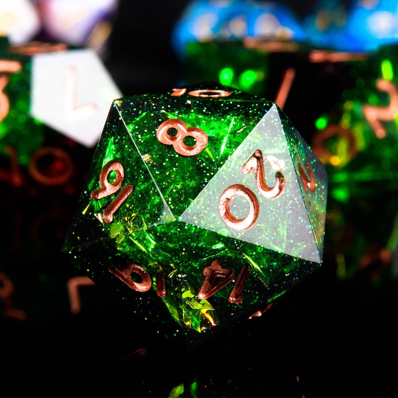 May include: A green, glittery, 20-sided dice with copper-coloured numbers. The dice is a popular tool for tabletop role-playing games.
