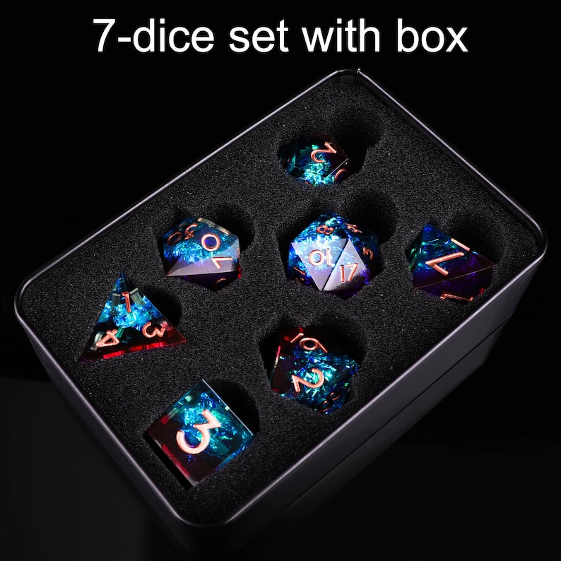 May include: A set of seven iridescent dice with copper numbers in a black box. The dice are blue, green, and purple with a glittery finish.