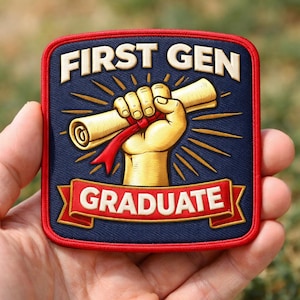 May include: A square patch with the words "FIRST GEN GRADUATE" in white lettering. The patch features a gold-colored hand holding a diploma with a red ribbon against a navy blue background, framed by a red border.