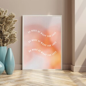 May include: A motivational poster with a pink and orange gradient background. The text "DO MORE OF WHAT YOU LOVE" is repeated three times in a curved arc.