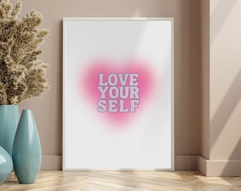May include: A white framed print with a pink heart shape and the text "LOVE YOUR SELF" in purple letters.