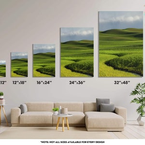 May include: A series of canvas prints showcasing a vibrant landscape of rolling green hills under a cloudy sky. The prints vary in size, from 8"x12" to 32"x48", displayed above a beige sofa. The artwork features a winding path through the fields.