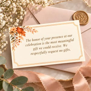 May include: A rectangular white card with a double-line gold border and autumn leaf illustrations in the top left corner. The text reads: The honor of your presence at our celebration is the most meaningful gift we could receive. We respectfully request no gifts.