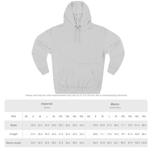 May include: A light gray hoodie with a drawstring hood and a kangaroo pocket. The image includes a size chart with measurements in inches and centimeters. The hoodie is a casual garment.