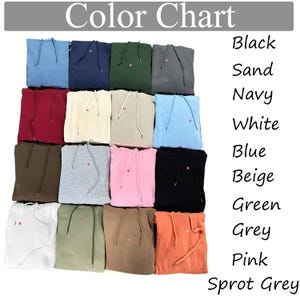 May include: A color chart displays a variety of hooded sweatshirts in various colors, including blue, navy, green, and grey. The text "Color Chart" is at the top. The color options are listed on the right side of the image, such as black, sand, navy, white, blue, beige, green, grey, pink, and sprot grey.
