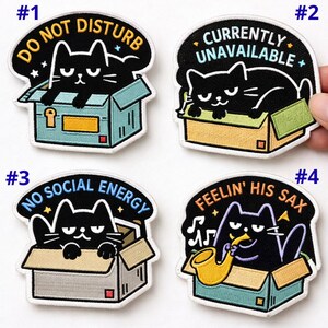 May include: Set of four embroidered patches featuring black cats in boxes with humorous phrases. Phrases include "Do Not Disturb," "Currently Unavailable," "No Social Energy," and "Feelin' His Sax."