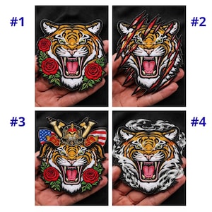 May include: Four embroidered patches featuring tiger faces. The patches are in various designs, including a tiger with roses, a tiger with claw marks, a tiger with a helmet and American flag, and a tiger with a smoky effect.