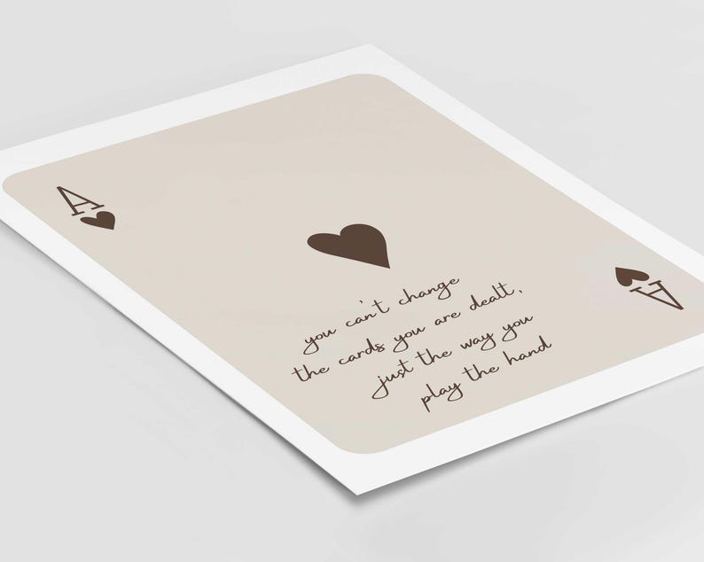 Op de afbeelding: Een beige kaart met een bruine aas van harten en de tekst "you can't change the cards you are dealt, just the way you play the hand".