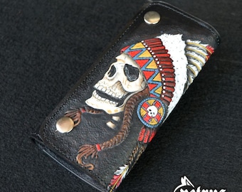 May include: Black leather wallet with a hand-tooled design of a skull wearing a colorful Native American headdress.