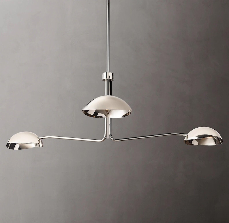 May include: A chrome three-light pendant light fixture with three dome-shaped shades.