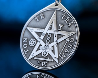 May include: A silver pendant with a five-pointed star and the words "TETRAGRAMMATON" inscribed around the perimeter. The star has a chalice, a sword, a wand, a pentagram, and a caduceus inside.