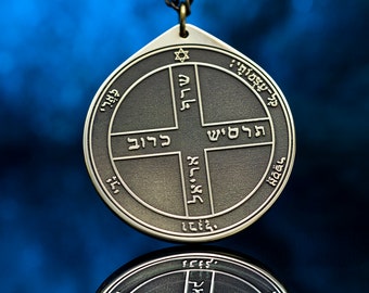 May include: A brass pendant with a Star of David and Hebrew text on a blue background. The pendant is hanging from a chain.