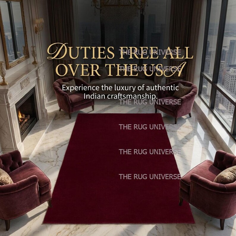 Deep wine color solid area rug displayed in a luxury modern living room with large windows and city views. Plush handcrafted rug with rich burgundy tone adds warmth and elegance to contemporary interior decor. Perfect for living room, bedroom, or apartment styling, this handmade rug features a smooth, soft texture and premium finish, ideal for modern, minimalist, and luxury home interiors.