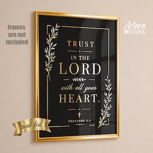 May include: A rectangular wall art print featuring a black background with gold foil text that reads Trust in the Lord with all your heart. Proverbs 3:5. The design includes gold botanical leaf accents and a thin gold border frame.