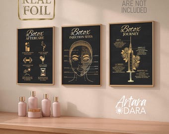 May include: Three framed black and gold posters with the words "Botox" and related information. The posters are displayed on a light-colored wooden surface, with several pink cosmetic bottles and jars in front. The words "Real Foil" are in a gold frame above the posters.