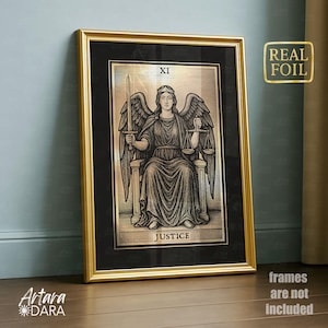 May include: A framed tarot card print featuring the Justice card. The artwork depicts a seated figure with wings, holding a sword and scales. The frame is gold, and the print has a black background. The text "REAL FOIL" is visible.