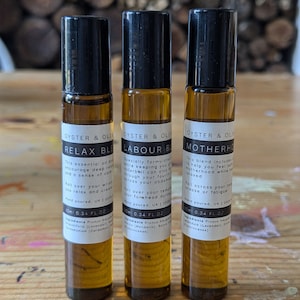 May include: Three brown glass roller bottles with black caps and white labels. The labels read "Relax Blend", "Labour Blend", and "Motherhood Blend". Each bottle contains 10 ml (0.34 fl oz) of essential oil blend.