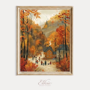 May include: A framed print of an autumn landscape with a village scene. The artwork features vibrant orange and yellow trees, a path with people, and houses with smoke rising from chimneys. The print has a light-colored wooden frame and the artist's signature.
